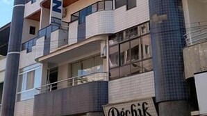 A multi-story hotel with a distinctive curved facade, balconies on each floor, and a visible sign for 'North Hotel'. - NortHotel (Barra De Sao Francisco)