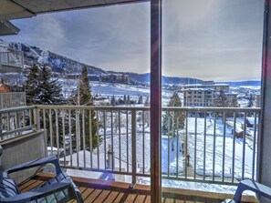 A balcony with a view of a snow-covered landscape, including a ski resort and buildings. - ⭐️ Ski Run Steps Away, 2 Hot Tubs, Private Deck (Steamboat Springs)