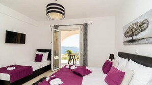 A hotel room with two beds, a TV, a painting, and a balcony with a view. - Apartments A&M - Studio with Terrace and Sea View No. 2 (Mlini)