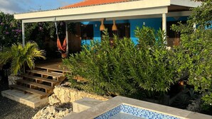 A house with a tiled swimming pool, a covered patio, and a red-tiled roof. - Sol Patch at Jeremi #2: a seaside guest house overlooking the Caribbean. (Willemstad)