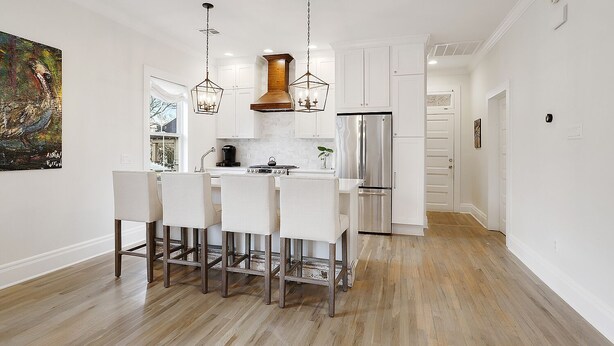 A modern kitchen with a central island, stainless steel appliances, and pendant lighting. - Luxury Cottage in Historic Beauregard Town  (Baton Rouge)
