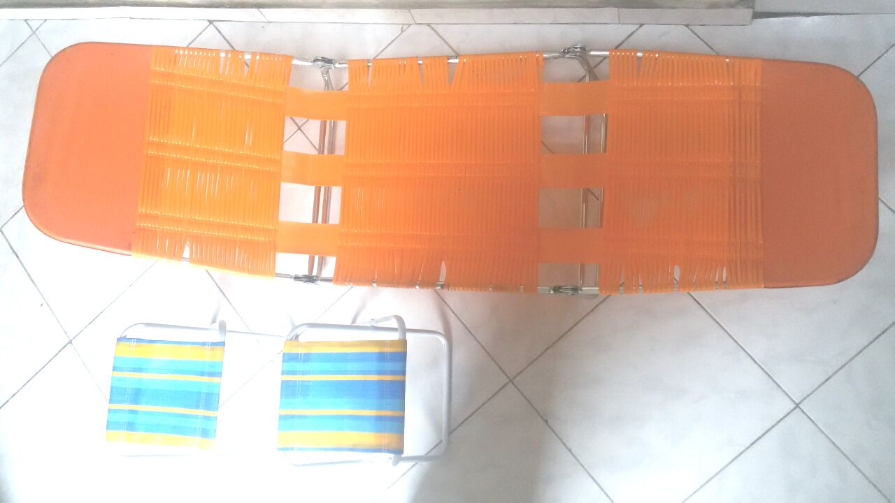 A tiled floor with a large orange object and two smaller blue and yellow objects.
