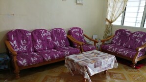 A living room with a sofa set and a coffee table. - Guest house transit to Langawi Island (Kuala perlis)