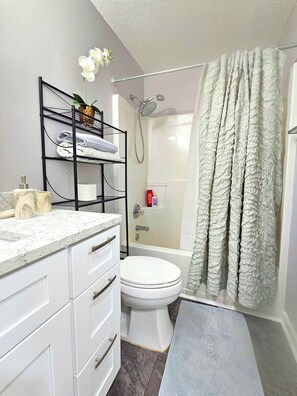 Bathtub, hair dryer, towels, soap