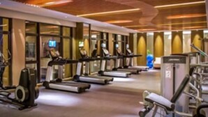 A gym with treadmills, stationary bikes, and weight machines. - Winlong International Hotel (Quanzhou)