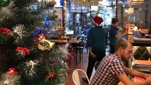 A restaurant with a decorated Christmas tree, a bar area, and hanging light fixtures. - Old Quarter View Hanoi Hostel (Hanoi)