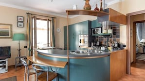 A compact kitchen with a curved island, a microwave, and a sink. - Villa La Massa - Exclusive Use - Heated Pool (Castel San Niccolo  -  Arezzo)