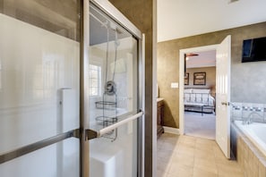 A modern bathroom with a glass shower enclosure, a bathtub, and a visible toilet. - Beautiful 2 story brick home on a cul-de-sac. A beautiful pond in the back yard (Poquoson)