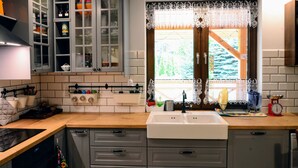 A kitchen with a window, cabinets, and a sink.