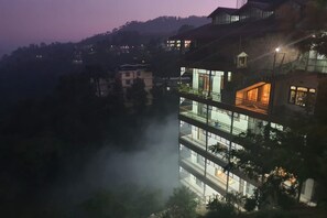 A multi-story building with balconies and a modern architectural design. - Cross Winds West (Shimla)