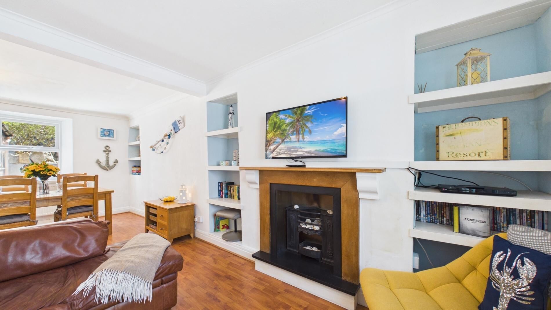 A living room with a fireplace, a television, and a bookshelf.