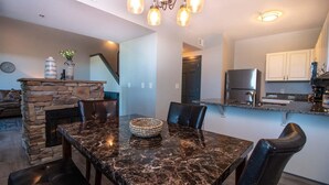 A modern kitchen with granite countertops, a built-in oven, and a stainless steel refrigerator. - 3206 Golf View Hillcrest The Clubhouse (Pigeon Forge)
