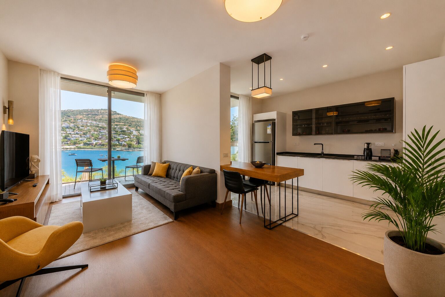 A modern living room with a sofa, dining table, and kitchen area.
