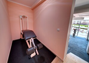 A room with a massage table, a small window, and a view of the outside. - Maria Palace (Nessebar)