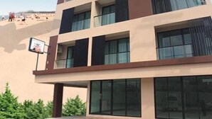A multi-story hotel with a modern architectural design, featuring large windows and balconies. - Louis' Runway View Hotel (Mai Khao)