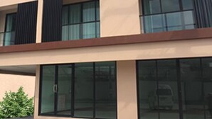 A multi-story hotel with a prominent sign reading "Louis Vuitton". - Louis' Runway View Hotel (Mai Khao)