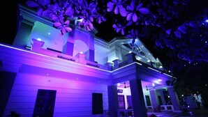 A large, multi-story building with a grand entrance and a covered porch area. - Novem Inn & Holidays (Sylhet)