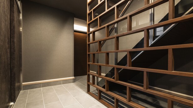 A modern interior with a staircase, a wooden partition, and a tiled floor. - Grand Base Nagasaki (Nagasaki)