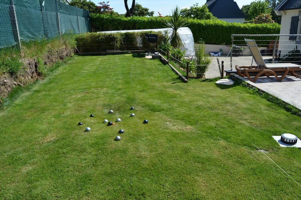 Une pelouse bien entretenue, avec un jeu de croquet et un espace salon abrité.