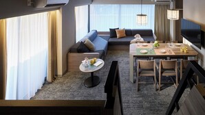 A modern hotel room with a sofa, dining table, and a TV. - Minn Ueno Iriya (Tokyo)