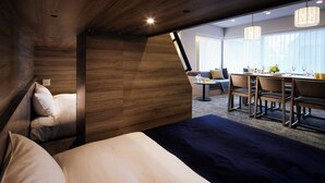 A modern hotel room with a large bed, a dining area with a table and chairs, and a sofa. - Minn Ueno Iriya (Tokyo)