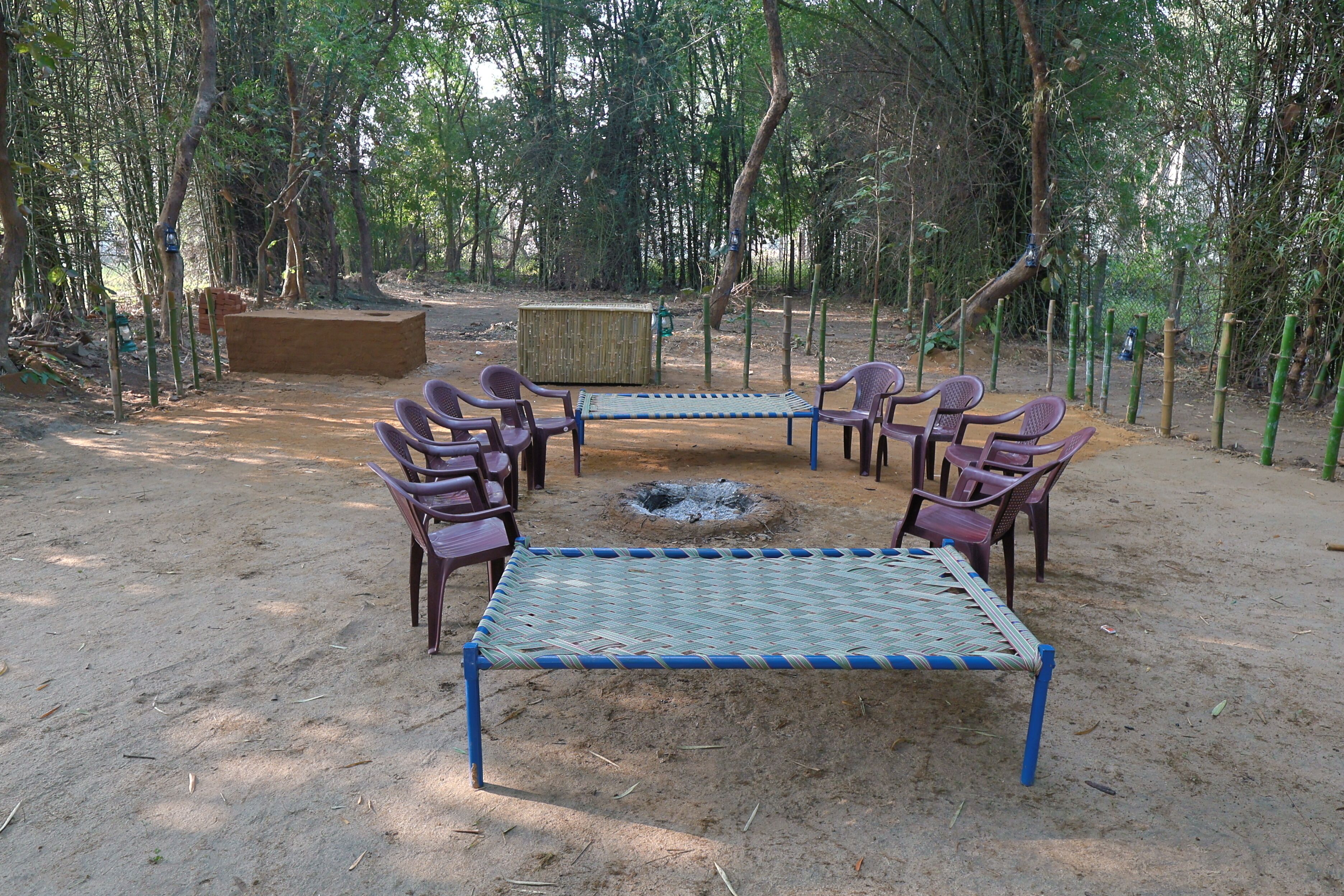 An outdoor seating area with a fire pit and chairs.