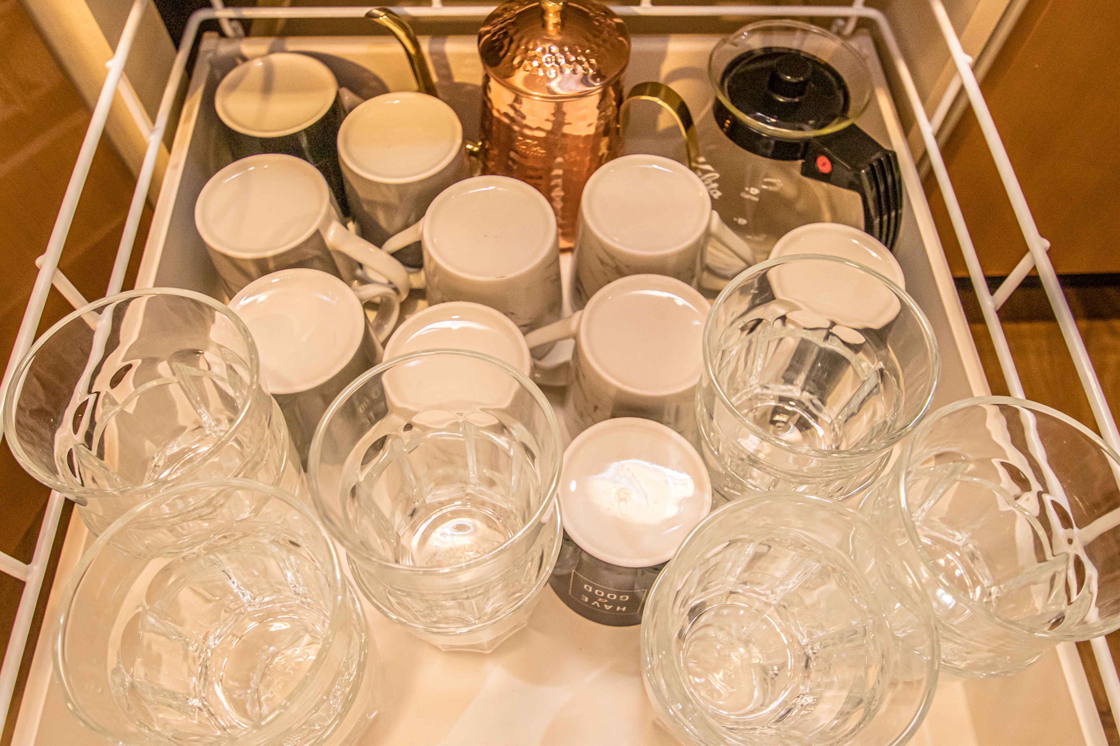A tray with various glassware and a decorative item.