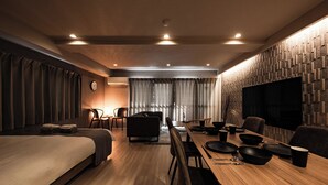A modern hotel room with a bed, a dining area, and a TV. - Crice Hotel Namba II (Osaka)
