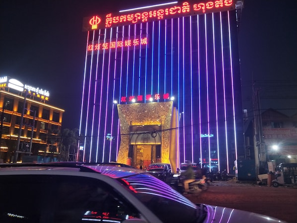 Welcome to a vibrant urban destination with a striking entrance featuring intricate patterns and a welcoming archway.