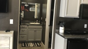 A modern kitchen with grey cabinets, a black refrigerator, and a microwave. - Modern Studio excellent location. (Grand Junction)