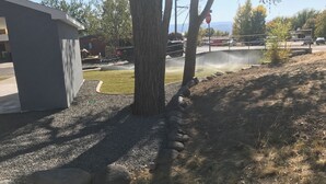 A residential area with a tree, a gravel path, and a stop sign. - Modern Studio excellent location. (Grand Junction)