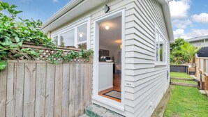 A single-story house with a wooden fence, a small porch, and a visible door number 635A.