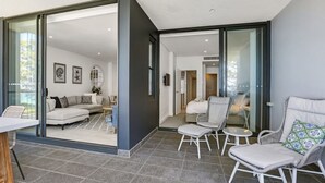 A modern interior with a living area, a dining space, and a bedroom. - 204 on the Beach by Experience Jervis Bay (Huskisson)