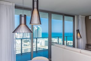 A balcony with a city view, two pendant lights, and a sofa. - Hollywood Beach HHouse Rentals (Hollywood)