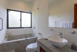 Enjoy a relaxing soak in the bathtub or refreshing shower, paired with a sleek sink and ample natural light.