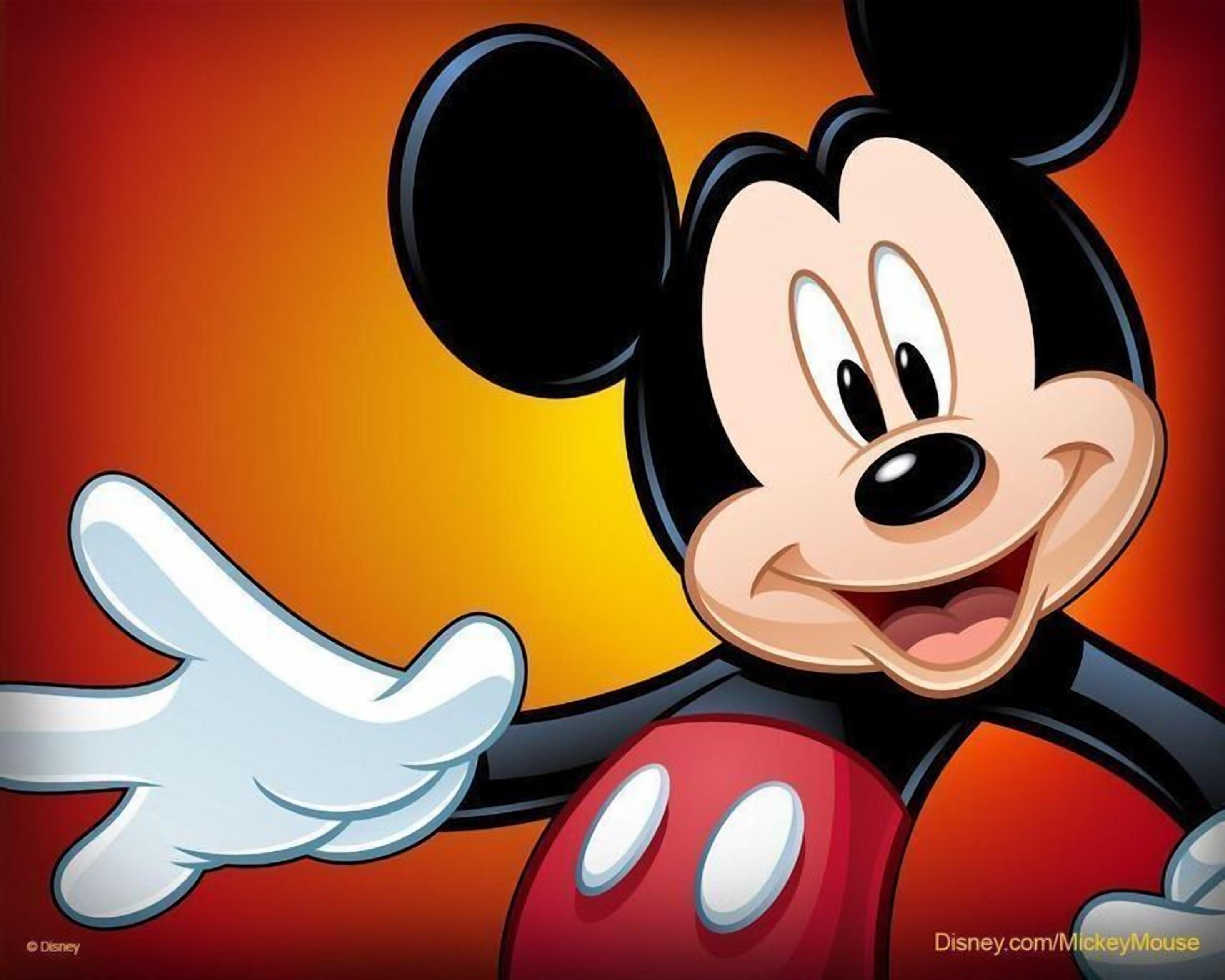 A cartoon character with a smiling face, large ears, and a red outfit.