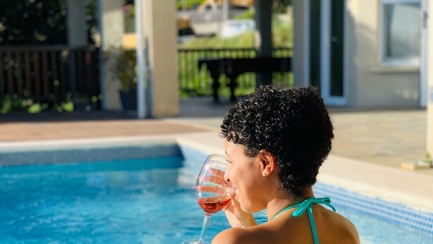 A person sitting in a swimming pool wearing a turquoise bikini. - Villa Xona (Castries)