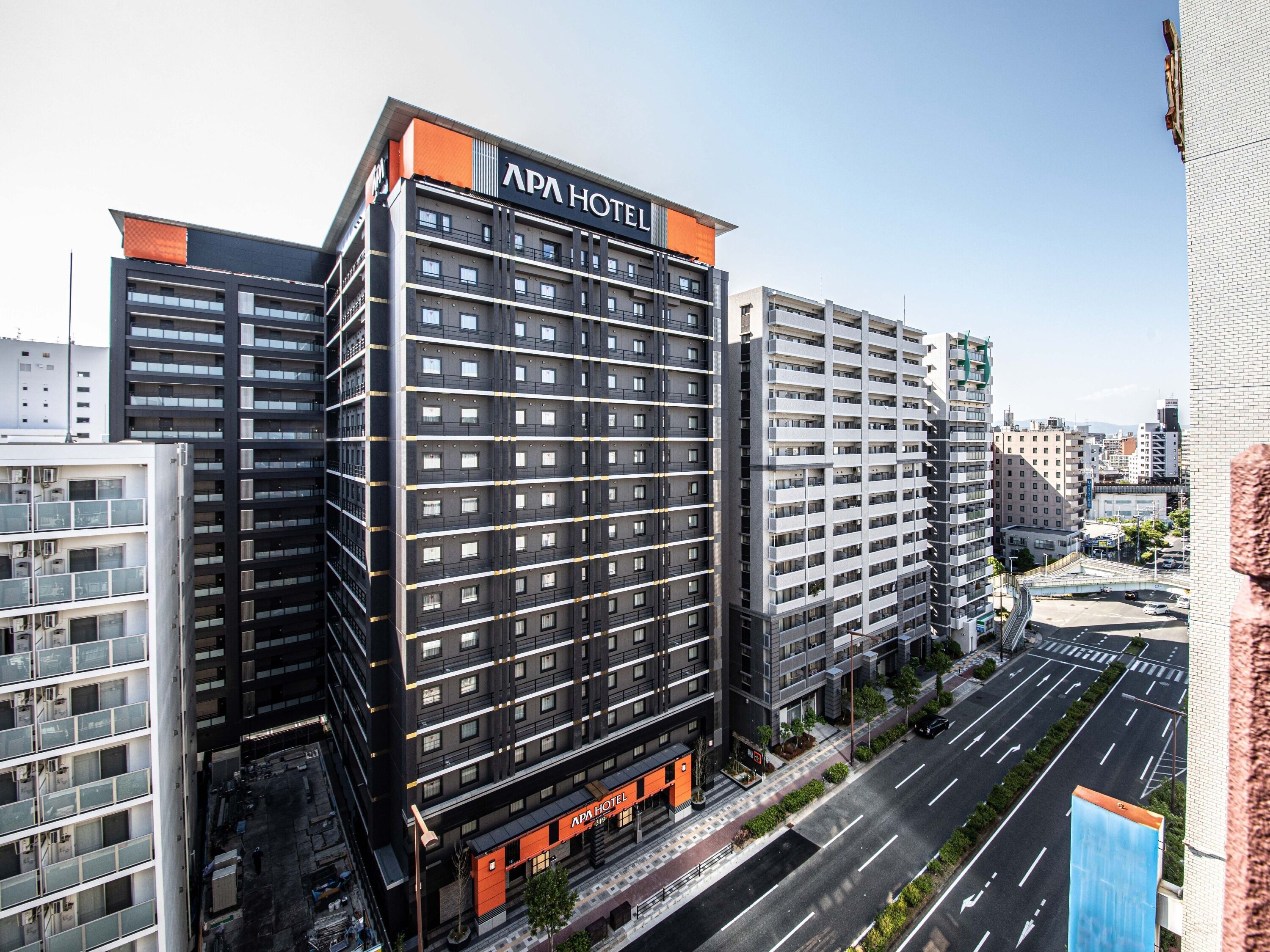 A multi-story hotel with a prominent sign reading "APA HOTEL".