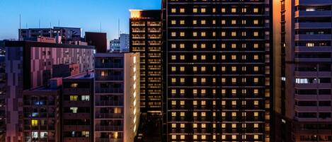 A multi-story hotel with a prominent sign reading "APA HOTEL".