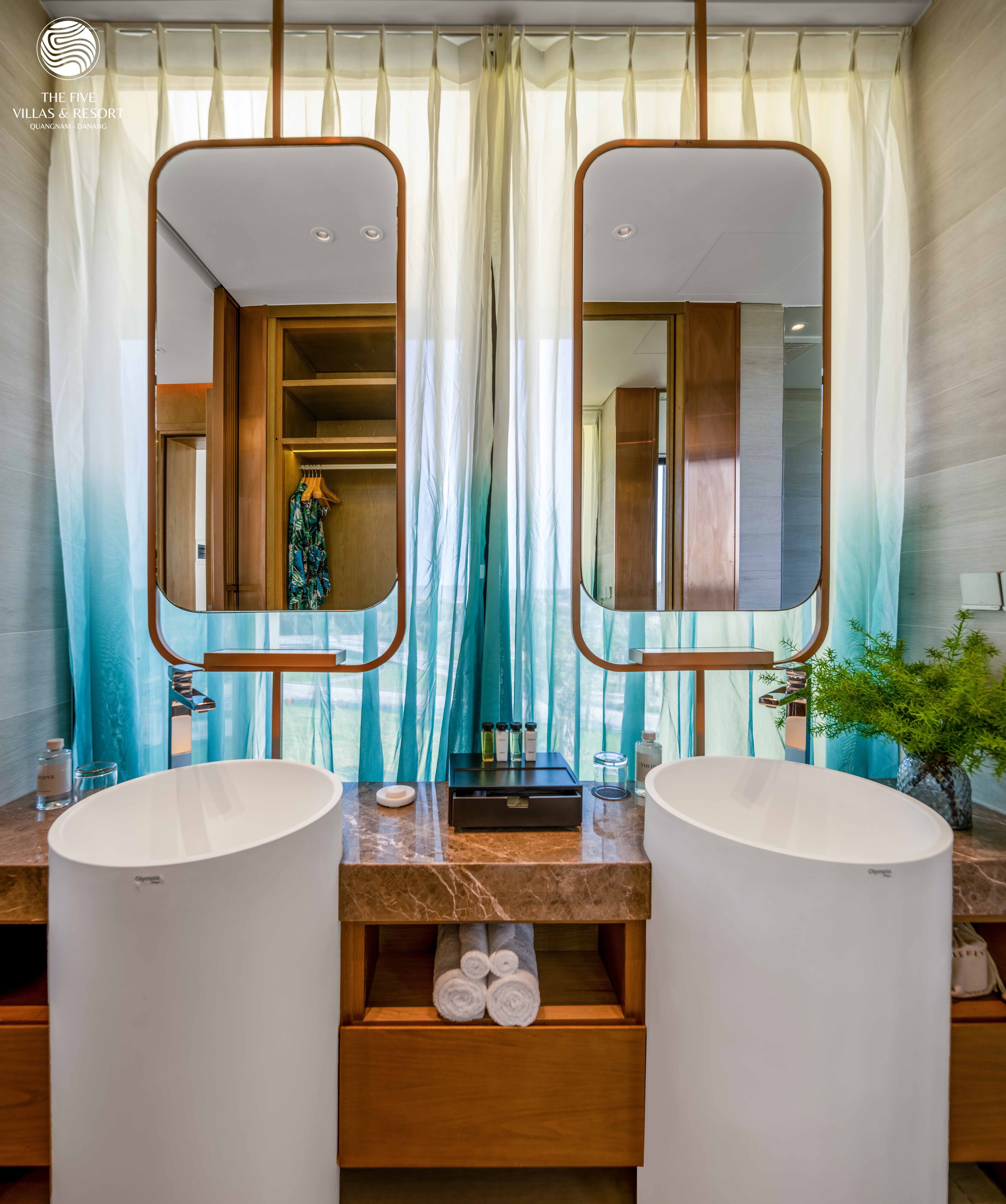 A bathroom with two sinks, a mirror, and a vanity.