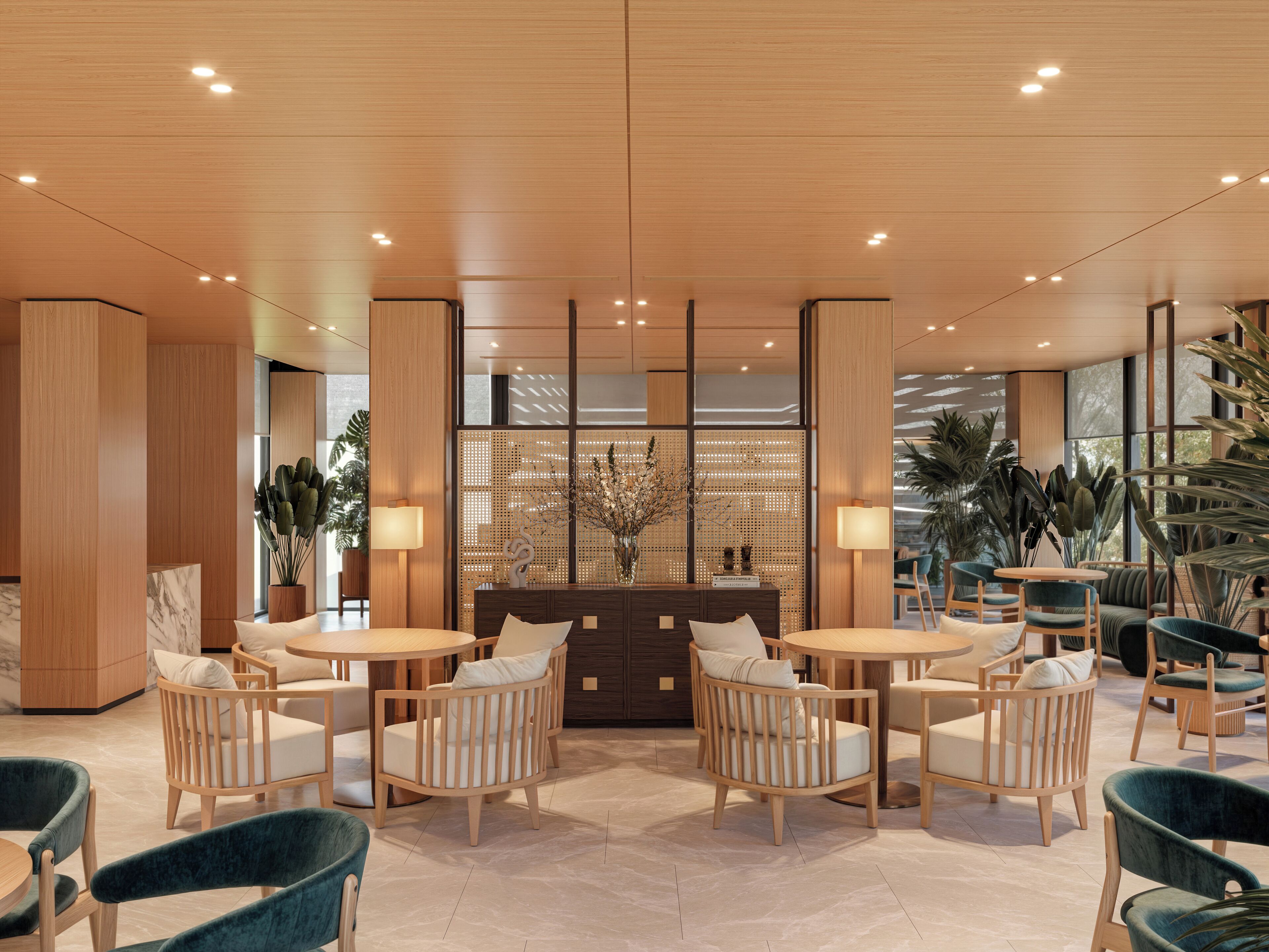 A modern lobby with wooden flooring, round tables, and comfortable seating.