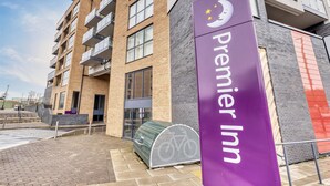 A Premier Inn building with a purple sign, brick facade, and balconies. - Premier Inn London New Southgate (London)