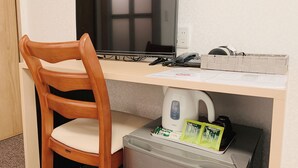 A workspace with a computer, a chair, a kettle, and a trash bin. - Allcomein Hotel (Tokyo)