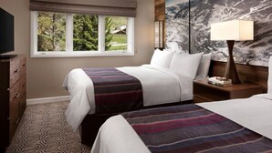 A hotel room with two beds, a window with a view of trees, a lamp, and a wall with a mountain painting. - Streamside at Vail Birch (Vail)