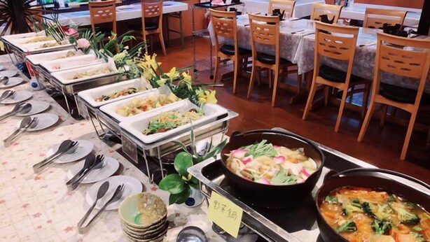 A buffet setup with various dishes and utensils. - Amami Lucky Life (Amami)