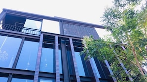 A modern building with large windows and a brick facade. - The LOCAL Ari - Hostel (Bangkok)