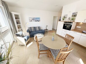 A modern apartment with a living area, dining space, and kitchen.