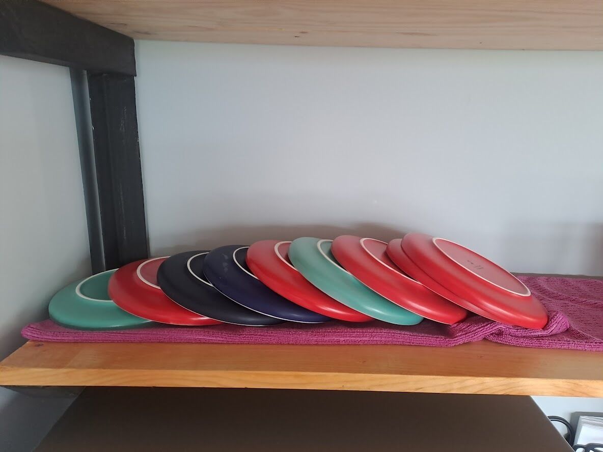 A shelf with a row of colorful plates.
