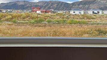 Premium bedding, laptop workspace, blackout curtains, soundproofing