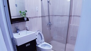 A modern bathroom with a toilet, sink, and shower. - SERVICED APARTMENT FOR RENT IN PHU NHUAN DISTRICT (Ho Chi Minh)